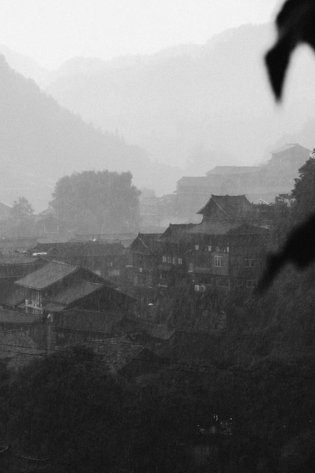 Light rays over a misty mountain village